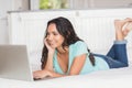 Happy brunette using her laptop Royalty Free Stock Photo