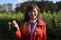 Happy brunette woman in red coat smiling and holding a set of keys Royalty Free Stock Photo