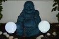 Happy Buddha Illuminated By Two Led Light Spheres In A Night Of Eclipse. Art, Religion, Night Photography, Happiness. Royalty Free Stock Photo