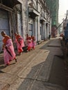 Buddhist child monks in pink robes in the streets of Yangon.