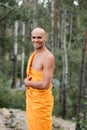 happy buddhist in orange kasaya smiling