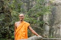 happy buddhist in orange kasaya walking