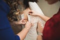 Happy buddies helps bride getting ready for her wedding day in the morning Royalty Free Stock Photo