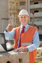 Happy builder in building site