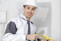 Happy builder in hardhat plastering wall Royalty Free Stock Photo