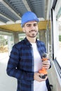 Happy builder man wearing white helmet with drill Royalty Free Stock Photo