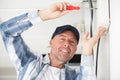 happy builder with screwdriver and cables Royalty Free Stock Photo