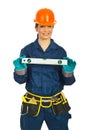 Happy builder woman holding bubble level Royalty Free Stock Photo