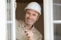 happy builder working on widow frame Royalty Free Stock Photo