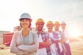 Happy builders and architect at construction site Royalty Free Stock Photo