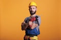 Happy building contractor holding power drill gun Royalty Free Stock Photo