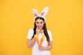 happy bunny woman in rabbit ears with carrot, easter