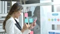 Happy  busimess Asian woman looking at paper note stick on glass board with success moment in office Royalty Free Stock Photo