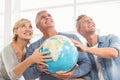 Happy business colleagues holding terrestrial globe Royalty Free Stock Photo