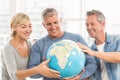 Happy business colleagues holding terrestrial globe Royalty Free Stock Photo