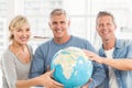 Happy business colleagues holding terrestrial globe Royalty Free Stock Photo