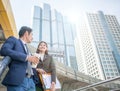 Happy Business colleagues talk outside office & talking to each other. Businessman talk and hold coffee cup. Royalty Free Stock Photo