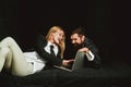 Happy business colleagues using laptop. Overjoyed couple look at laptop screen, excited happy young husband and wife