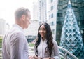 Happy Business colleagues walking outside office & talking to each other Royalty Free Stock Photo