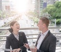 Happy Business colleagues walking outside office & talking to each other. Royalty Free Stock Photo