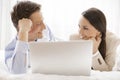 Happy business couple with laptop looking at each other in hotel Royalty Free Stock Photo