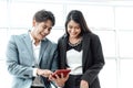 Happy business couple standing together  checking work on tablet. Royalty Free Stock Photo