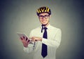 Happy business man in helmet using tablet computer Royalty Free Stock Photo