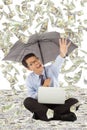 Happy business man holding a umbrella and catching money