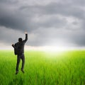 Happy business man jumping in green rice field and rainclouds Royalty Free Stock Photo