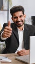 Happy business man looking approvingly at camera showing thumbs up, like positive sign, good news