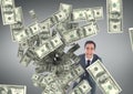 Happy business man looking at money rain against grey background Royalty Free Stock Photo