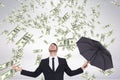 Happy business man looking at money rain against white background