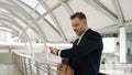 Happy business man looking watch while waiting his colleague at bridge. Urbane. Royalty Free Stock Photo