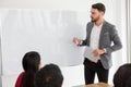 happy business man making a presentation on whiteboard . boss presenting strategy of marketing to goal of success with teamwork in Royalty Free Stock Photo