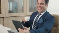 Happy business man reading news on his tablet he smiling Royalty Free Stock Photo