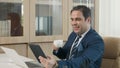 Happy business man reading news on his tablet he smiling Royalty Free Stock Photo