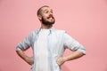 The happy business man standing and smiling against pastel background.