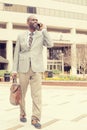 Happy business man talking on his phone while walking outside Royalty Free Stock Photo