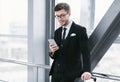 Happy business man texting on smart phone in airport Royalty Free Stock Photo