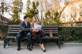 Happy Business Man and Woman Chatting on Bench. Royalty Free Stock Photo