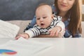 Young mother working and spending time with baby Royalty Free Stock Photo