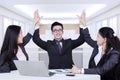 Happy business partners raising hands up Royalty Free Stock Photo