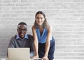 Happy business people at a desk using a computer against white wall Royalty Free Stock Photo