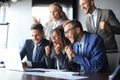 Happy business people laugh near laptop in the office. Successful team coworkers joke and have fun together at work. Royalty Free Stock Photo