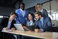 Happy business people laugh near laptop in the office. Successful team coworkers joke and have fun together at work. Royalty Free Stock Photo