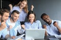 Happy business people laugh near laptop in the office. Successful team coworkers joke and have fun together at work Royalty Free Stock Photo