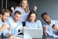 Happy business people laugh near laptop in the office. Successful team coworkers joke and have fun together at work Royalty Free Stock Photo