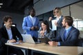 Happy business people laugh near laptop in the office. Successful team coworkers joke and have fun together at work. Royalty Free Stock Photo