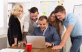 Happy business people team together look at laptop in office Royalty Free Stock Photo