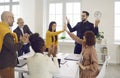 Team of happy business people celebrating their success during a work meeting in the office